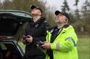 Two police officers operate drones during an operation carried out on the A338 Ringwood to Salisbury road