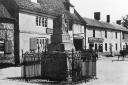 The Market Cross, High Street, Ludgershall outside the Queens Head, circa 1900.  Note the Temperance Hotel to the right of the pub. Photo from the John Marchment collection.