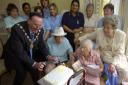 Celebrating: Phyllis Brown, aged 106, blows out the candles on her birthday cake with help from the Mayor and Mayoress of Test Valley, Brian Page and his wife Dorothy, as well as friends and staff at Millway House, Weyhill.