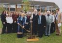 photograph taken by the Andover Advertiser in 2007 of Barbara planting the tree , with members of staff and pupils present to watch