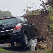 Vauxhall crashes into residential fence and telecoms box on major Andover road