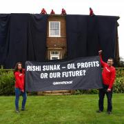 Greenpeace activists blanketed the home in black fabric in protest over Rishi Sunak’s North Sea oil announcement earlier this week