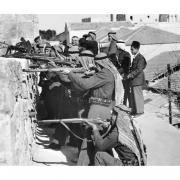 The soldiers of allied Arab Legion forces fire on fighters of the Haganah, the Jewish Agency self-defence force, in March 1948