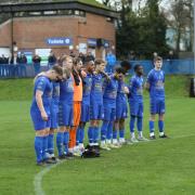 Andover Town players observe a minute’s silence as part of Armistice Day.