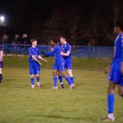Andover Town players celebrate after scoring their first goal against Millbrook