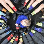 A photo of children wearing odd socks