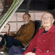 Alfred Naudi and Terry Holdsworth in the cockpit of a helicopter
