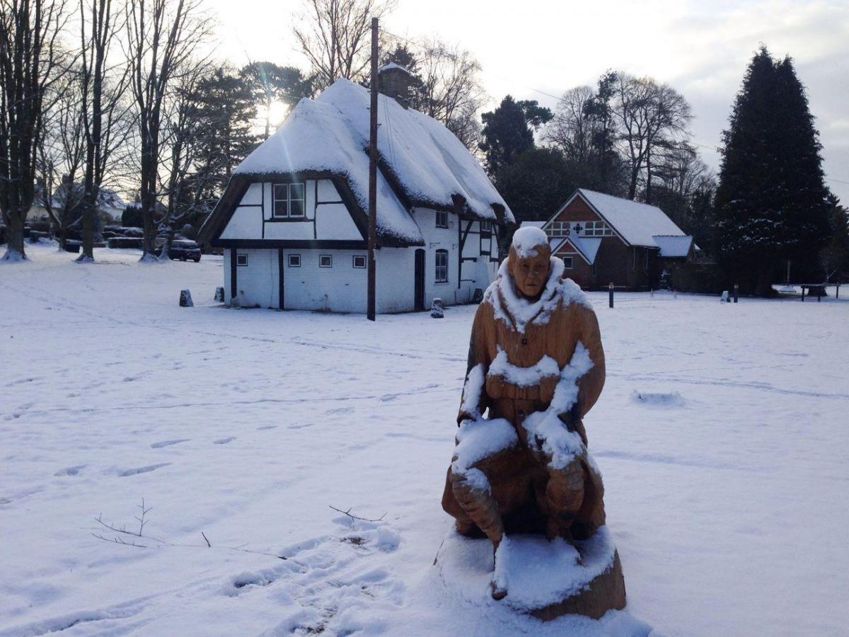 Enham Trust’s statue in the centre of the village –  entitled Moving On – this morning, covered in snow. Sent by Sophie Porter