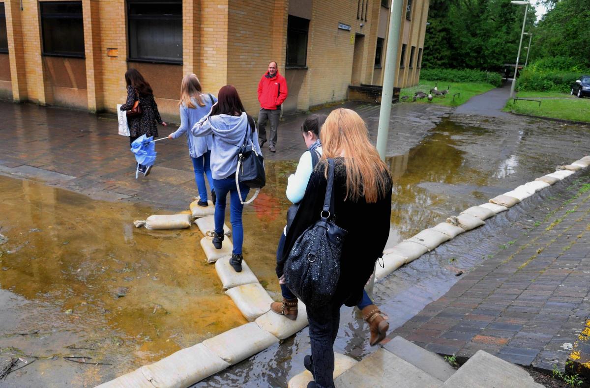 College Students crossing over flood water in 2013