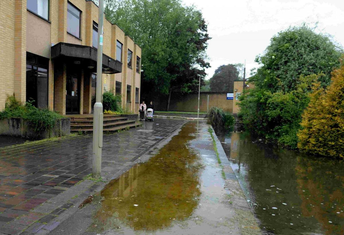 Flooding on pathway next to the Magistrates Court and College caused by a blocked culvert in 2013