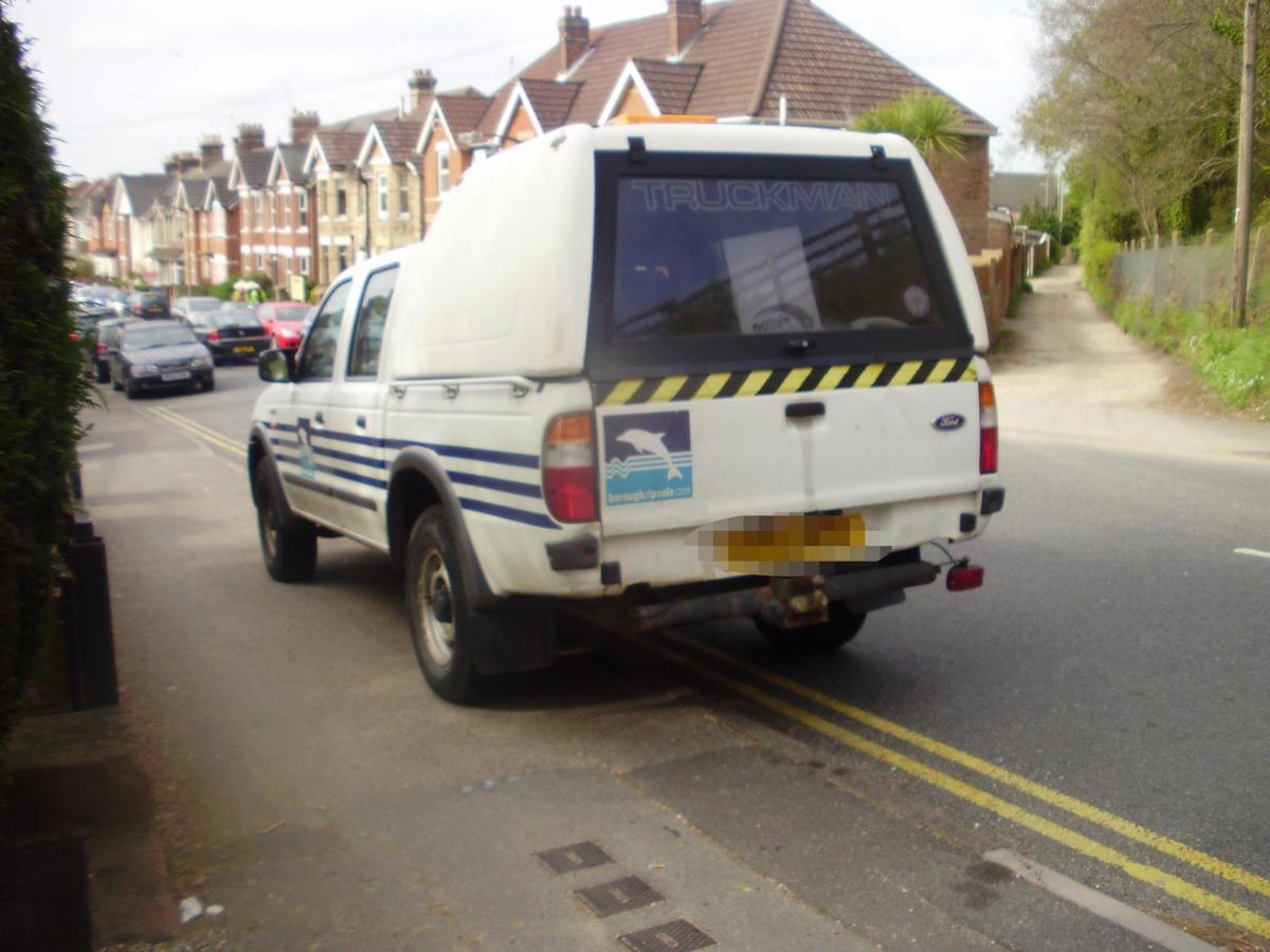 A council van - half on the pavement - half on double yellow lines