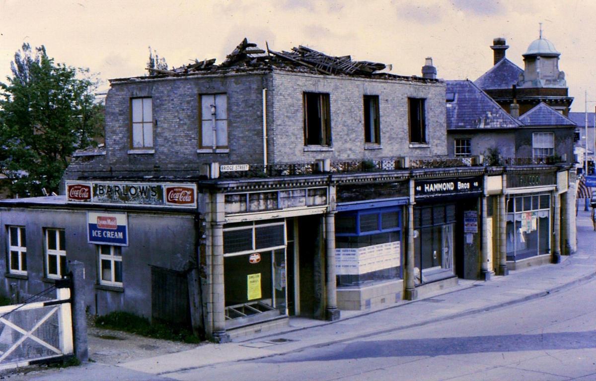 In the process of demolition. Some shops adjacent to the upper gate of the level crossing on Bridge Street.

Picture from Jeffrey Saunders collection