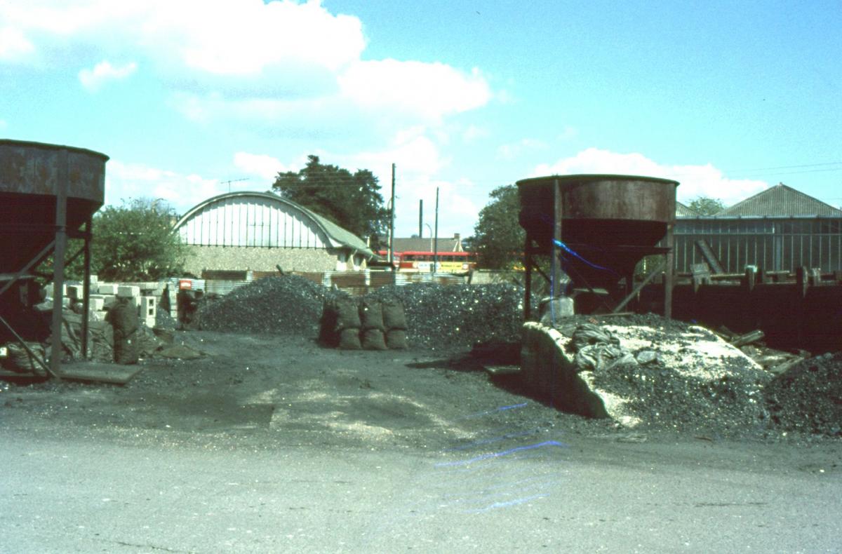 The Andover Coal yard (today the site of the Bridge Street Sainsbury's car park.  Hants and Dorset buses can be seen in the background. These are standing in the yard of the bus station.

Photo from the Jeffrey Saunders collection.