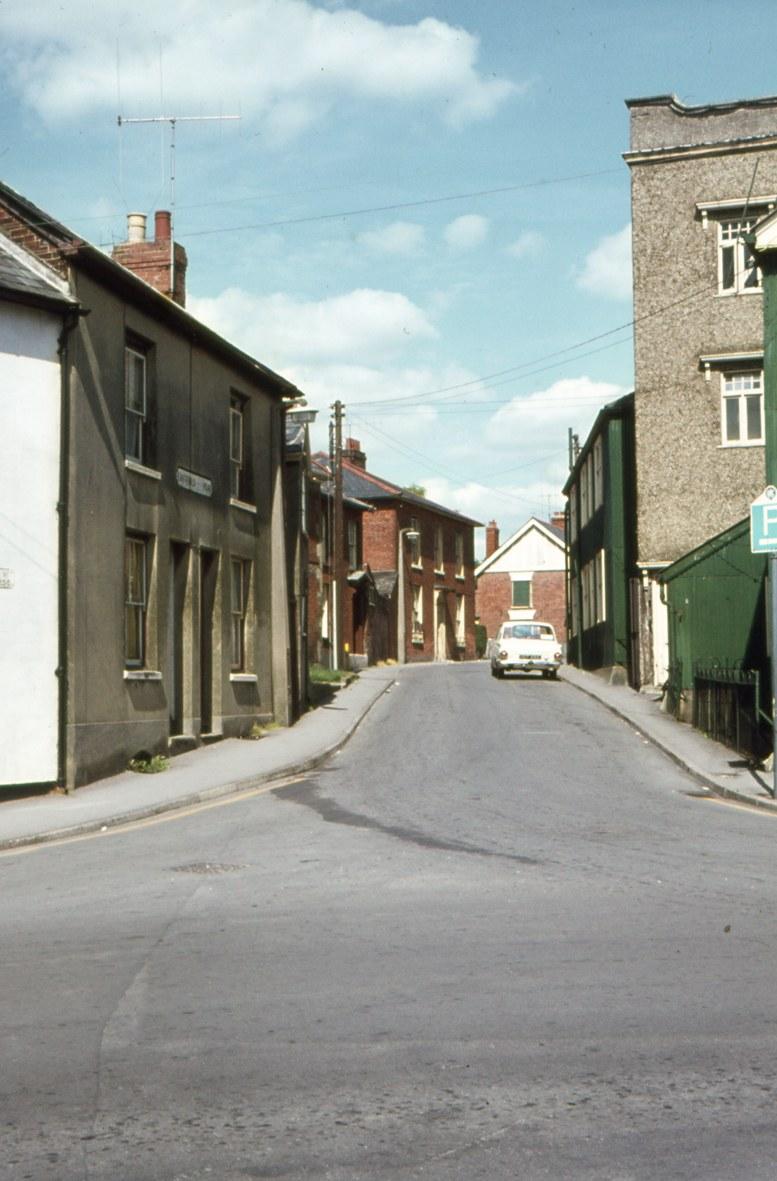 A view up Eastfield Road from East Street showing the Tower of the Drill Hall (in the 70s these buildings became the Country Bumpkin Club which burnt down in the early 80s.  The terraced houses to the left are long gone making room for the Rack Close flat