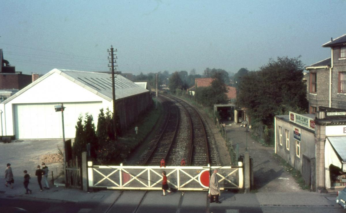 Taken from the footbridge at Andover Town Station looking north in the direction of Andover Junction Station (today's station) The track bed is the route today of Western Avenue.

Bridge Street level crossing.

Photo from the Jeffrey Saunders collecti