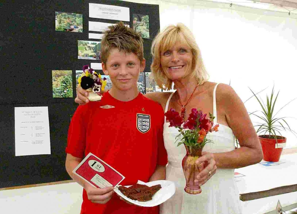 St Mary Bourne Fete and Flower Show 2006.  A young prize winner and his mum.