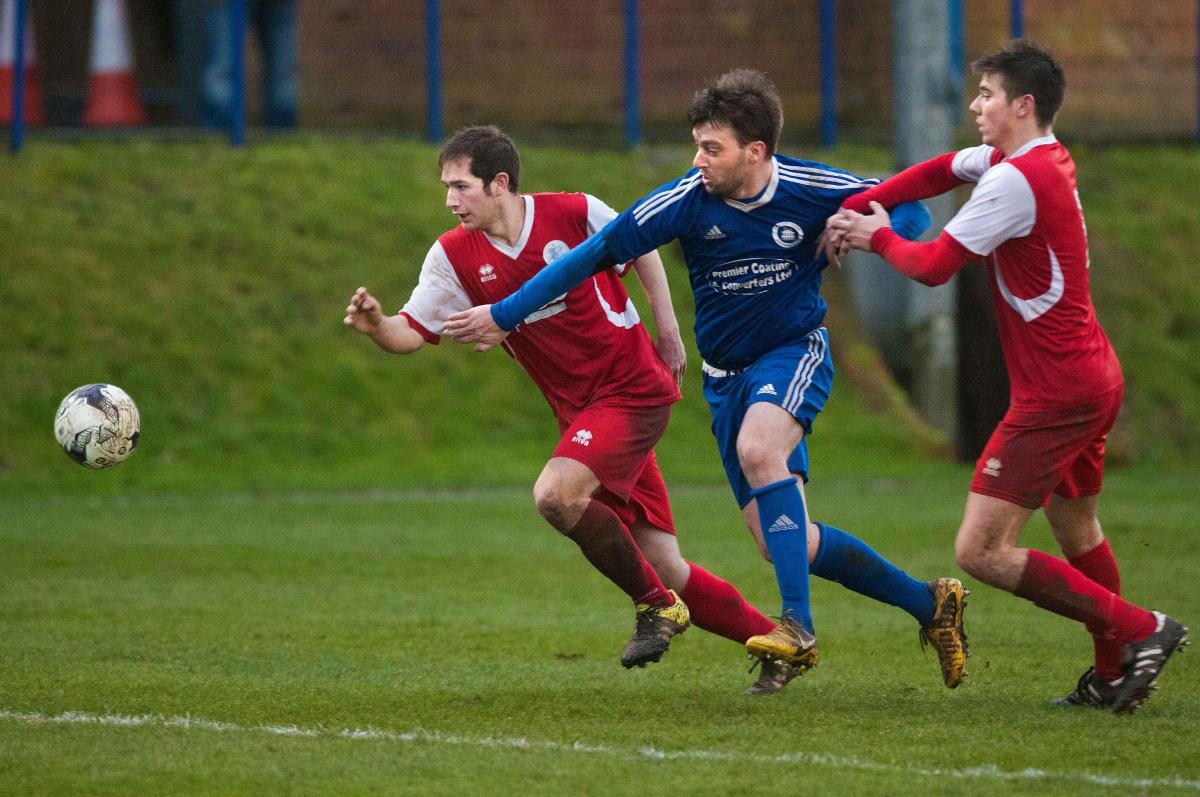 Andover Town's double goal scorer Zach Glasspool gets between two Fawley defenders in his side's 3-1 win at The Portway Stadium - Picture Andy Brooks