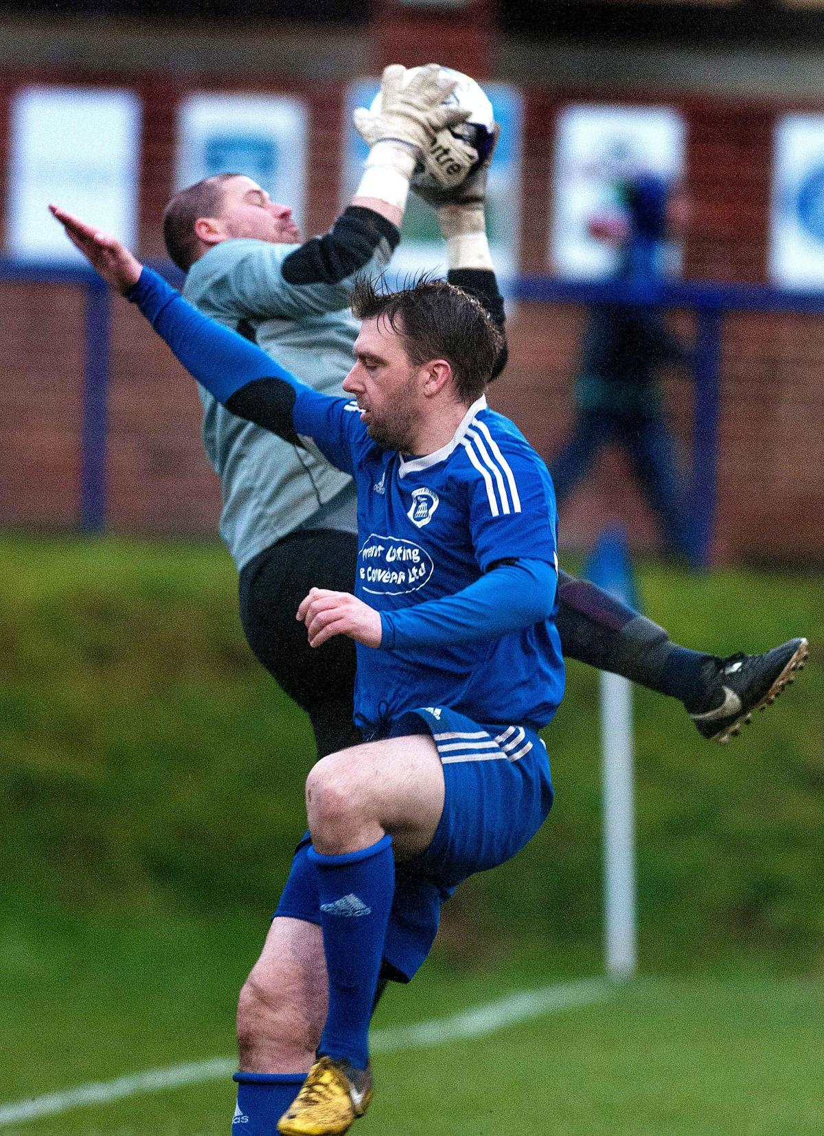 Andover Town's double goal scorer Zach Glasspool challenges the Fawley goalkeeper in his side's 3-1 win at The Portway Stadium - Picture Andy Brooks