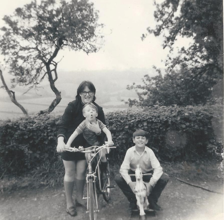 Stephen rides a bike with his sister Christine and his brother Brian