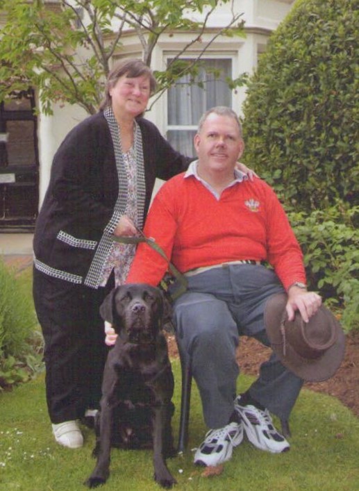 Stephen with his wife Vanessa and assistance dog Scott