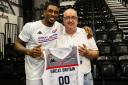 Former Love Island contestant and GB basketball star Ovie Soko presents Andrew Cattle with a signed shirt to be auctioned off for charity