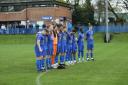 Andover Town players observe a minute’s silence as part of Armistice Day.