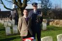 Michiel Vanmarcke stands at the grave of Pte Holiday with Gp Capt Justin Fowler Defence Attache to Belgium and Luxembourg