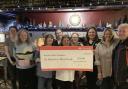 The Swan Inn staff present the cheque