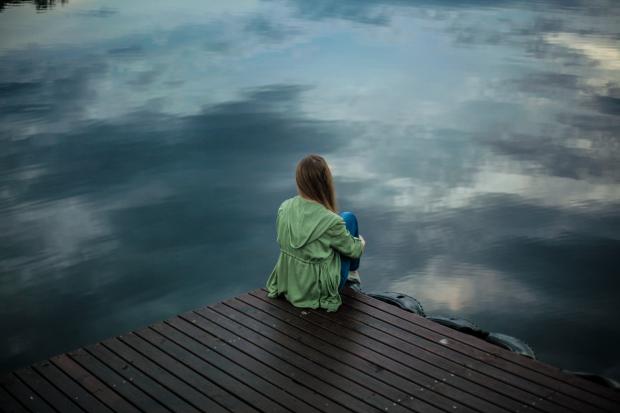 Andover Advertiser: A woman looking out on to the water. Credit: Canva