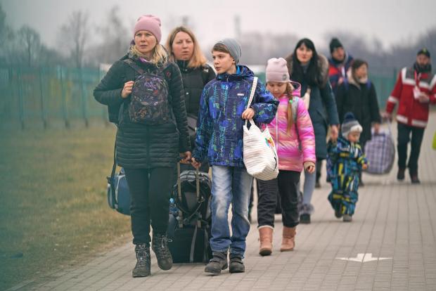 Andover Advertiser: People crossing the border point from Ukraine into Medyka, Poland. Photo via PA.