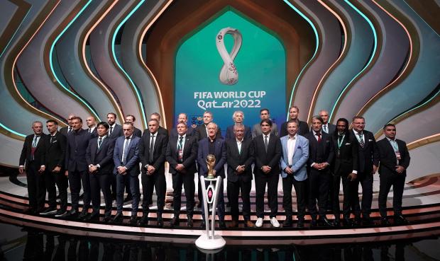 Andover Advertiser: Managers, including England manager Gareth Southgate (back row third left), on stage during the FIFA World Cup Qatar 2022 Draw. Picture: PA