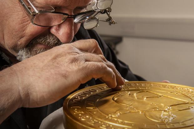 Andover Advertiser: Master craftsman Steve Dyer works on the 15 kilo gold coin by hand. Credit: The Royal Mint