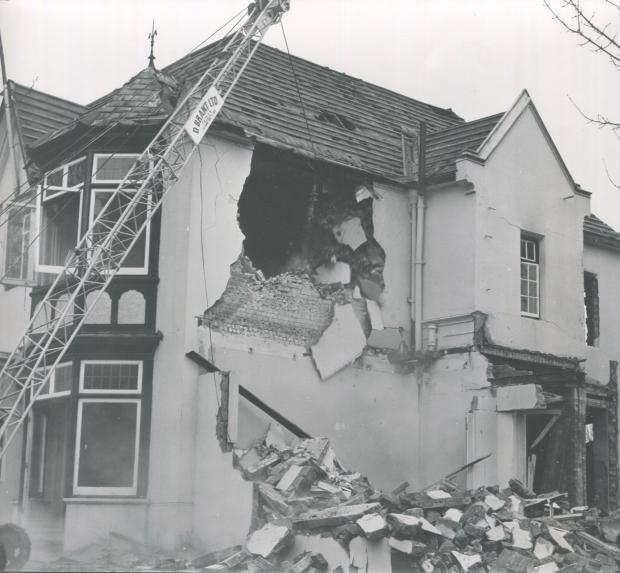 Andover Advertiser: Demolition in 1976, photographed by Charles Wardell, showing the decorative brick and flint walls beneath the plaster facade. 