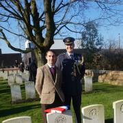 Michiel Vanmarcke stands at the grave of Pte Holiday with Gp Capt Justin Fowler Defence Attache to Belgium and Luxembourg