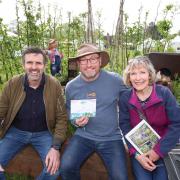 Gardeners World presenter Adam Frost, Boaz head of horticulture Andy Brooks and Boaz volunteer Heather Watson