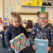 Children in Little Rooks Nursery showing off their wrapped purchases