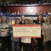 The Swan Inn staff present the cheque