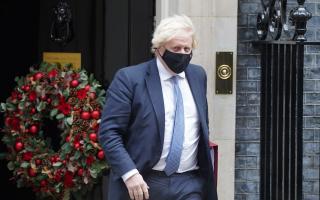 Boris Johnson outside a festive Downing Street. Credit: PA