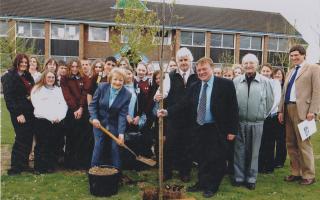 photograph taken by the Andover Advertiser in 2007 of Barbara planting the tree , with members of staff and pupils present to watch