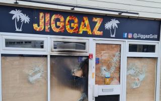 Jiggaz Grill was set on fire after vandals smashed the windows two days prior.