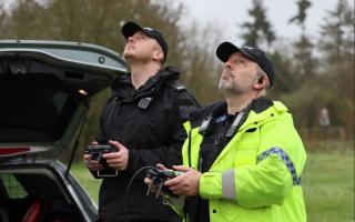 Two police officers operate drones during an operation carried out on the A338 Ringwood to Salisbury road
