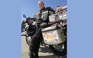 Nick Gilroy and the motorbike he used to travel through all of the states of the USA.